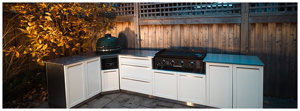 Green egg with Black stone in outdoor kitchen white cabinets