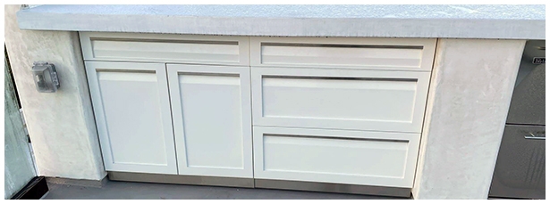 White outdoor cabinets in concrete countertops
